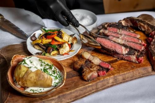 a plate of food with meat and vegetables on a table at Best Western Plus Hotel Erb in Parsdorf