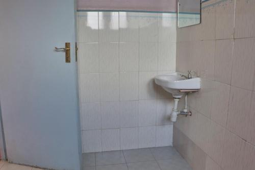 a bathroom with a sink and a mirror at 136 Boutique Address Hotel in Nairobi
