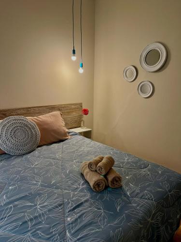 a bed with two towels on top of it at "Josefa" terraza y parrilla - Alojate Mendoza in Mendoza