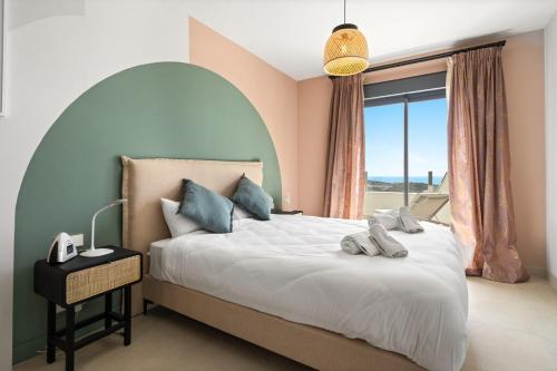 a bedroom with a large bed with a large window at Chic and stunning views on amazing terrace RDR484 in Mijas Costa