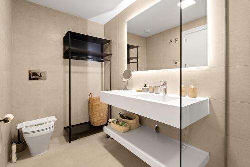 a bathroom with a white sink and a toilet at Chic and stunning views on amazing terrace RDR484 in Mijas Costa