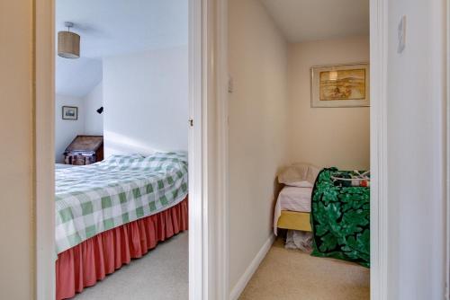 a small bedroom with a bed in a room at Charming Hilltop Cottage with Panoramic Views in East Worldham