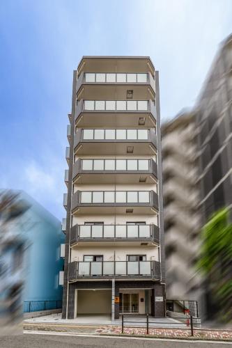 a tall apartment building in a city at 星之宿今宫 in Osaka