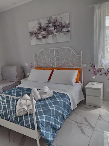 a bedroom with a bed with towels on it at Domus Pompeii Ruins in Pompei