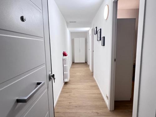 a hallway with white walls and wooden floors at Lory Smart - Relax e Natura by RD Domus in Moncalieri