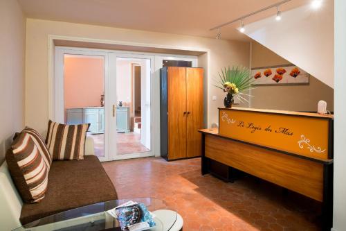a living room with a couch and a piano at B&B Le Logis Du Mas in Sète