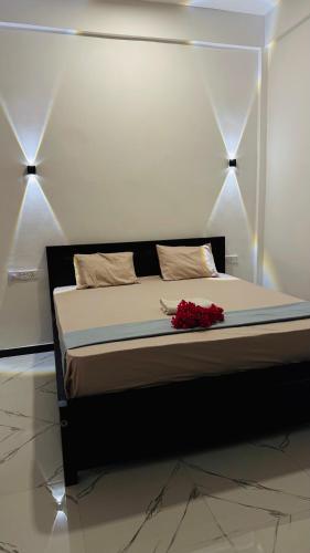 a bedroom with a bed with flowers on it at Baywatch Arugambay in Arugam Bay