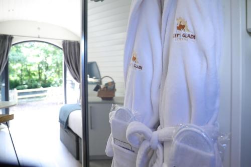 a room with a mirror and a robe with towels at Glamping Retreats in Norwich
