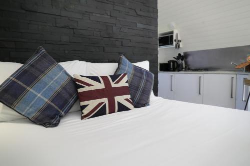 a white bed with pillows on top of it at Glamping Retreats in Norwich