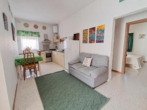 a living room with a couch and a kitchen at Double BEDROOM in Swatar in Birkirkara