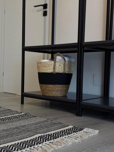 a basket on a shelf in a living room at Shtëpia Me Lule in Përmet