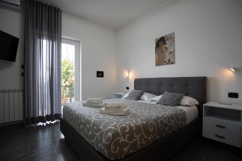 a bedroom with a large bed and a window at Light stadium in Taormina