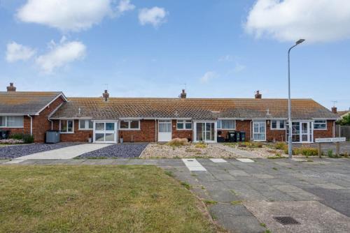 a brick house with a parking lot in front of it at Amazing Beachside 2BD Family Home with Garden in Cliftonville