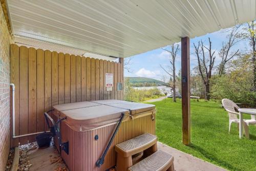 a hot tub sitting under a tent on a patio at Ski Cove #2 in McHenry