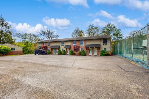 a house with a fence in front of a parking lot at Ski Cove #2 in McHenry