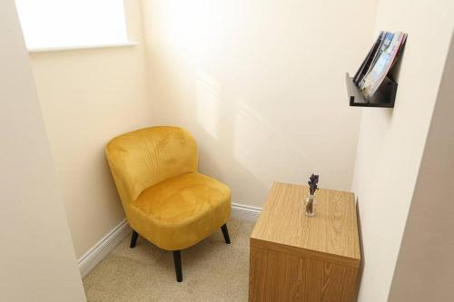a yellow chair and a table in a room at 3Bed/2Bath Duplex Apartment - Pure Bliss Belfast in Belfast