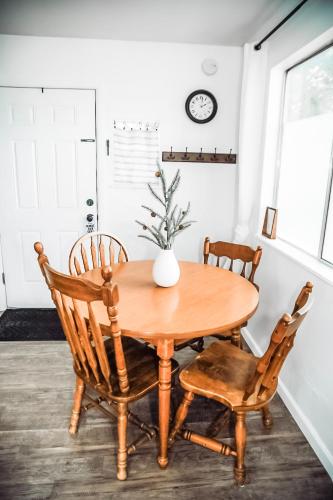 a dining room table with two chairs and a vase on it at House-1 Bedroom, 1 Bath-Private, Centrally Located in Kalispell