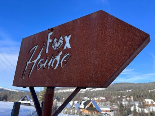 a sign for a ski lodge in the snow at Domki Fox House z jacuzzi elektrycznym na wyłączność in Kościelisko