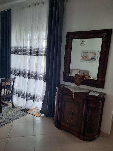 a mirror on top of a dresser in a room at Anushe's apartament in Pogradec