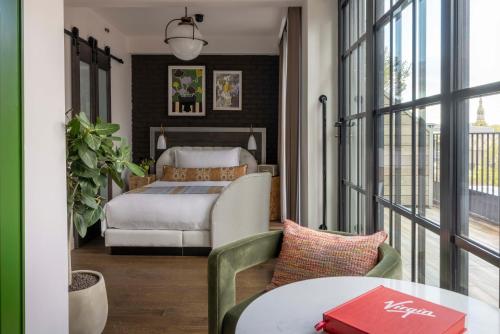 a hotel room with a bed and a table at Virgin Hotels London - Shoreditch in London