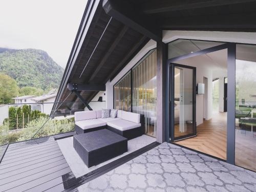 a living room with a couch on a balcony at Appartements Prielau by we rent, SUMMERCARD INCLUDED in Zell am See