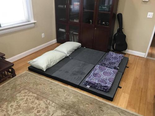 a bed sitting on the floor in a room at 501 Lovely Bmore Inner Harbor Suite! in Baltimore