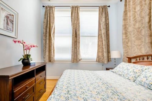 a bedroom with a bed and a dresser and a window at 501 Lovely Bmore Inner Harbor Suite! in Baltimore