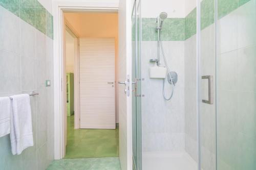 a bathroom with a shower with a glass door at Casa Margherita vista Etna in Calatabiano