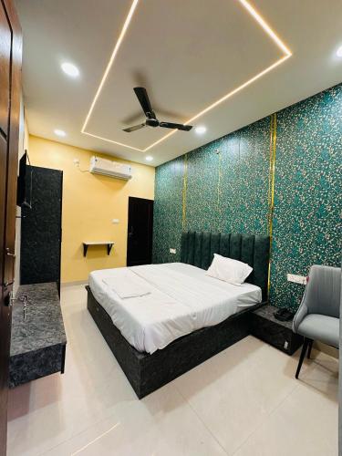 a bedroom with a bed and a wall with green tiles at Hotel Airport Suites Suitable for Hourly Bookings in Lucknow