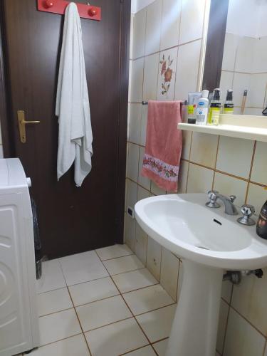 a bathroom with a white sink and a shower at Nettuno beachfront house in Nettuno