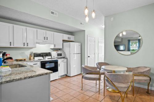 a kitchen with white appliances and a table and chairs at Lovely 3br Apartment for 7 - Near Ark Encounter in Williamstown