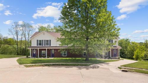 a house with a tree in the driveway at Lovely 3br Apartment for 7 - Near Ark Encounter in Williamstown