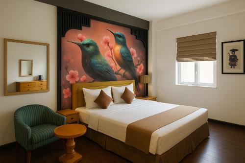 a bedroom with a bed and a painting of birds at Hanoi Golden Sunshine Villa Hotel and Travel in Hanoi
