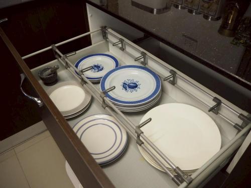 a group of plates sitting in a drawer at Private 2-storey house in Chiang Mai By The Orchard in Chiang Mai