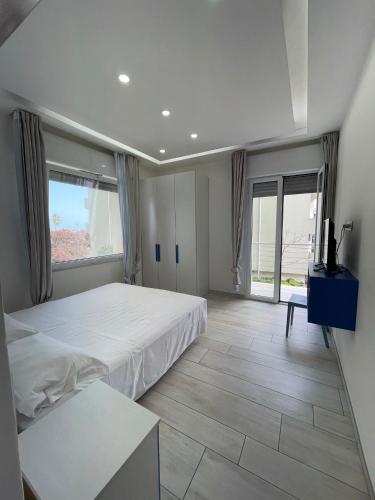 a bedroom with two beds and a large window at Wave House in Montesilvano