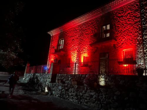 a red building with lights on it at night at Villa Maria in Marano Principato