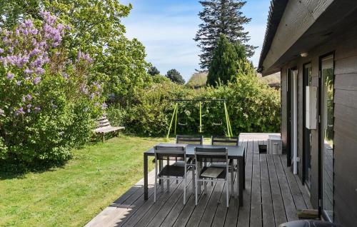 a patio with a table and chairs on a house at Amazing Home In Bogø By With Wifi in Bogø By