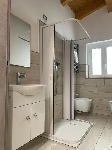 a bathroom with a shower and a sink and a toilet at Wave House in Montesilvano