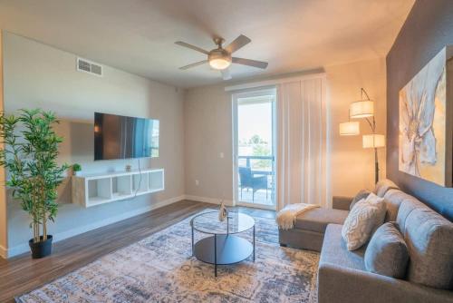 a living room with a couch and a tv at Modern 2BD - Gym, Pool, Parking, W-D - Sleeps 8 in Tempe