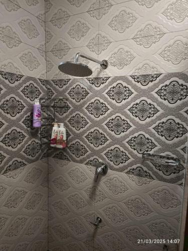 a shower in a bathroom with a tiled wall at Private 2-storey house in Chiang Mai By The Orchard in Chiang Mai