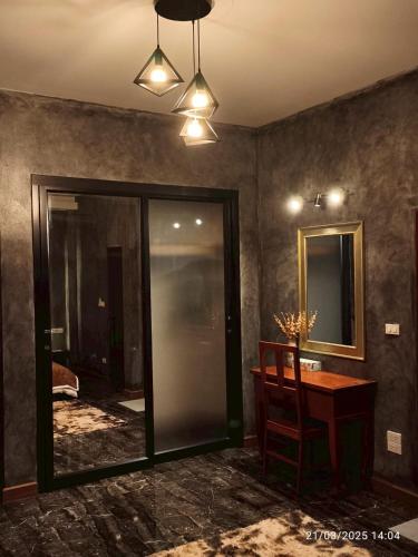 a room with a table and a chair and a mirror at Private 2-storey house in Chiang Mai By The Orchard in Chiang Mai