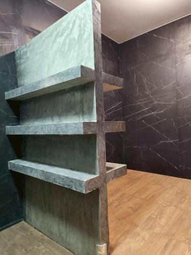 a concrete shelf in a room with a wall at Private 2-storey house in Chiang Mai By The Orchard in Chiang Mai