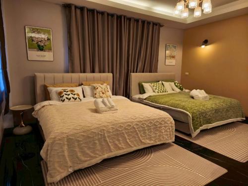 a bedroom with two beds in a room at Private 2-storey house in Chiang Mai By The Orchard in Chiang Mai