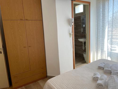 a bedroom with a bed with two towels on it at Hotel Barbiani in Riccione