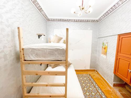 a bedroom with a bunk bed in a room at Bubbly Hostel Marrakech in Marrakech