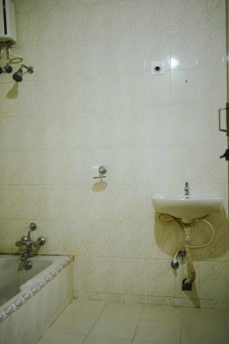 a bathroom with a sink and a bath tub at Varkala- Aroma Ac pvt Villa hammocks kitchen in Varkala