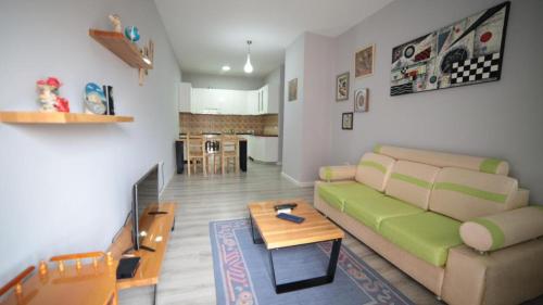 een woonkamer met een bank en een tafel bij Hotel Bujtina Shqiptare in Tirana