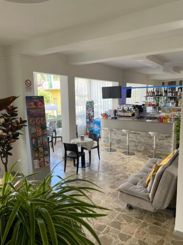 a living room with a couch and a table at Hotel Barbiani in Riccione