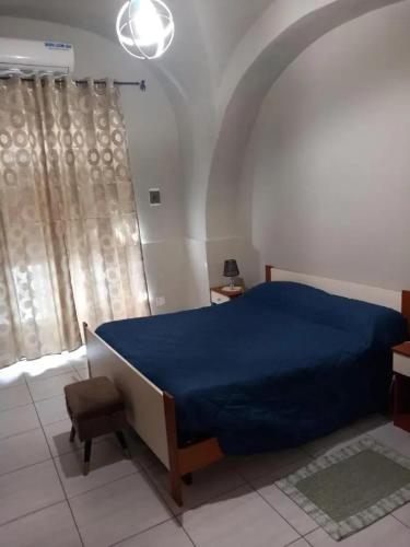 a bedroom with a blue bed and a window at Modern Studio in Catania with Air Conditioning in Catania