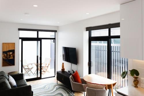 a living room with a couch and a table at Chic 2BR Apartment - Secure Gated Complex in CBD in Wellington